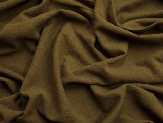 Close-up of brown fabric with folds on a white background