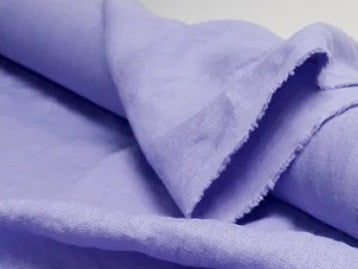 Roll of purple fabric on a white background